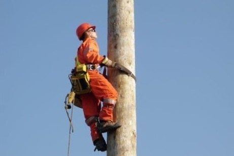 woman lineworker hydro pole