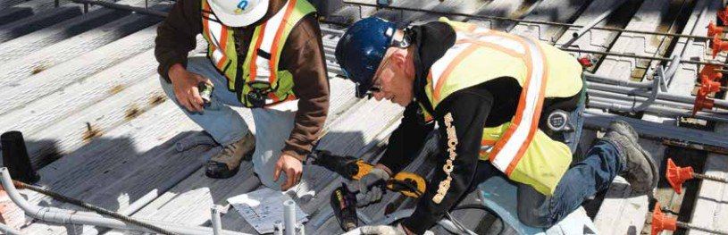 Electricians at work on rooftop job site